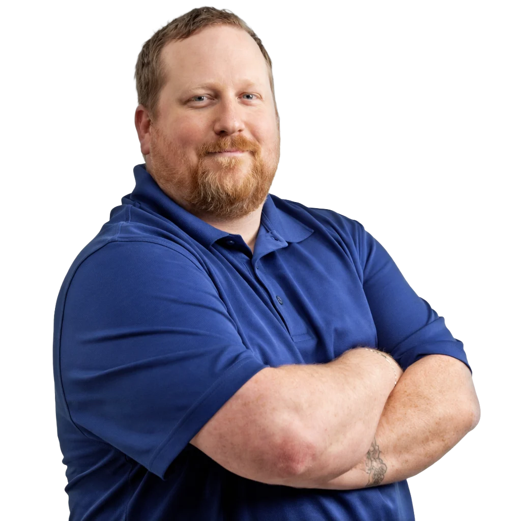 Dylan Lillie wearing blue polo shirt, arms crossed, smiling at camera
